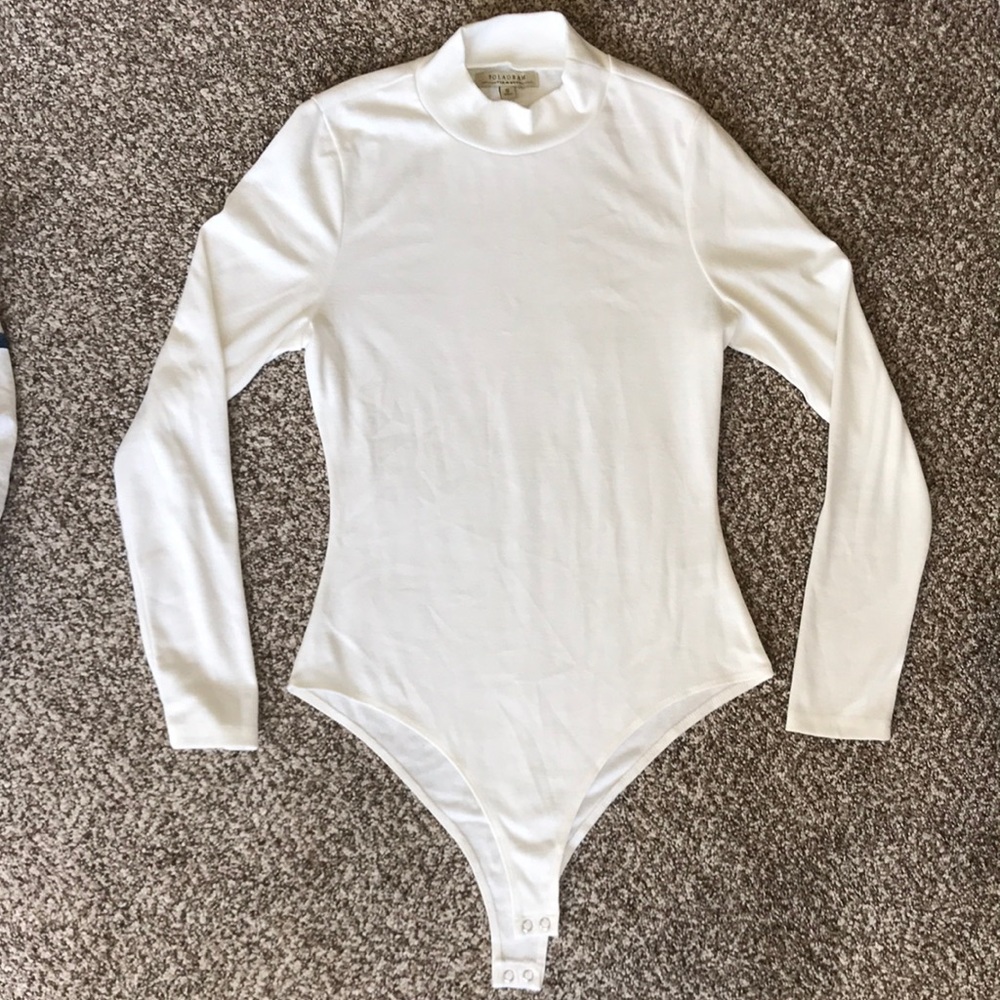 Small white women’s body suit. Never worn.